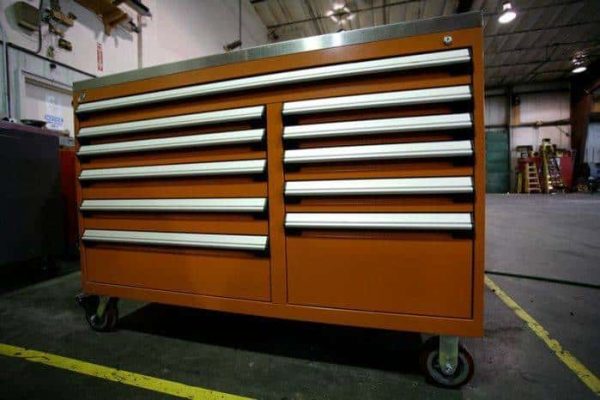 Red heavy duty multi drawer cabinet in a warehouse setting.