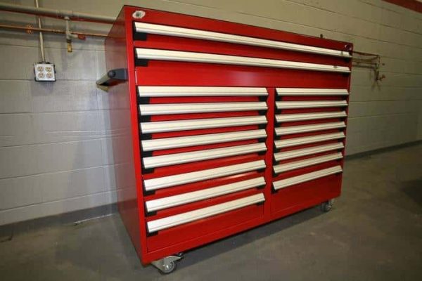 Red heavy duty multi drawer cabinet in a warehouse setting.