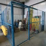 Blue security wire fencing in a warehouse setting.