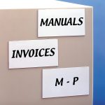 Three write on magnetic tags on a box with "manuals" "invoices" and "M-P" written on them.