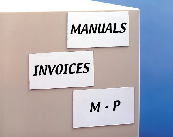 Three write on magnetic tags on a box with "manuals" "invoices" and "M-P" written on them.