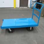 Blue clearance platform truck in a warehouse setting.