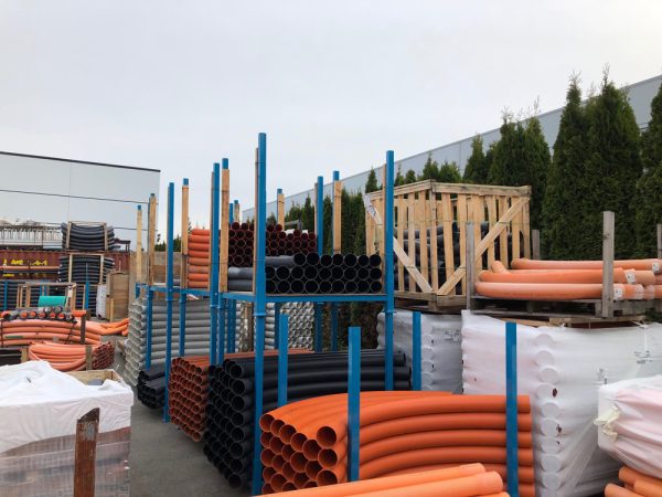 Bulk stacking storage racks holding materials in an outdoors setting.