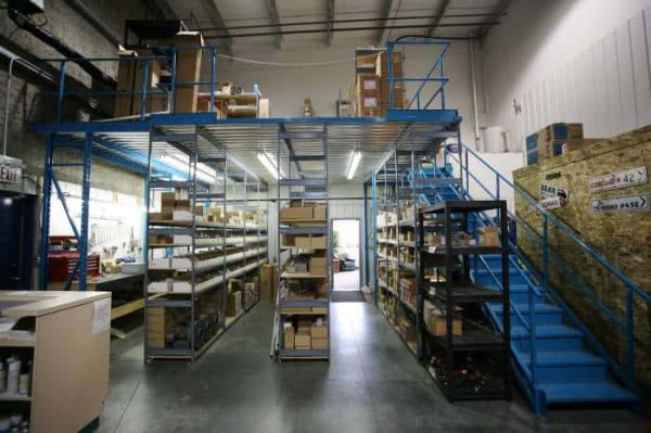 Blue handrail system in a warehouse setting.