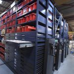 Mechanical mobile shelving in a warehouse setting.