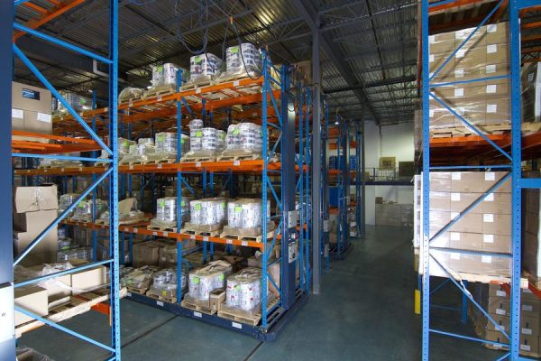 Mobile pallet racking system in a warehouse setting.