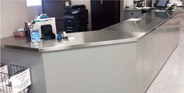 Stainless steel corner workstation in an office setting.