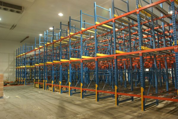 Gravity flow roller racks in a warehouse setting.