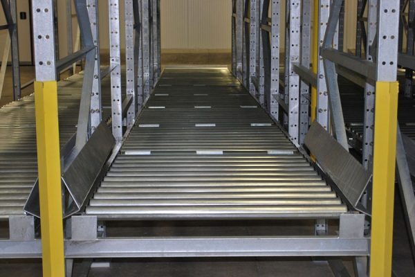 Gravity flow roller racks in a warehouse setting.