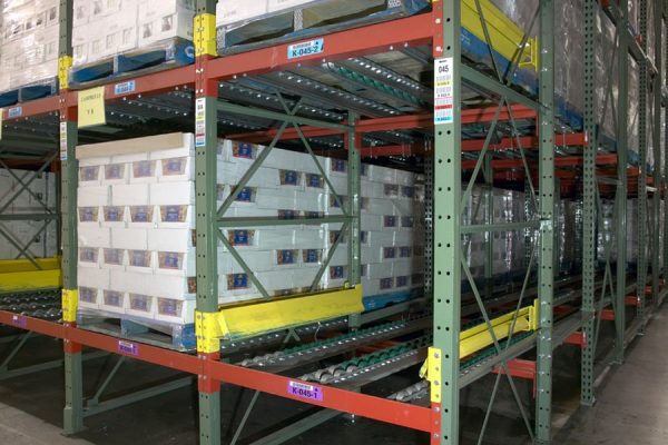 Gravity flow roller racks in a warehouse setting.