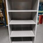 Grey Rousseau closed shelving unit with 5 shelves in a warehouse setting.